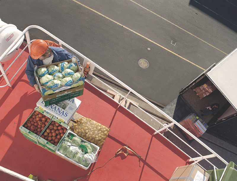 vessel crewmember lifting salad and other provisions onto vessel